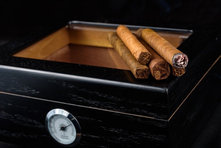 cigar advisor best glass top humidor guide - cigars sitting on top of a glass top humidor