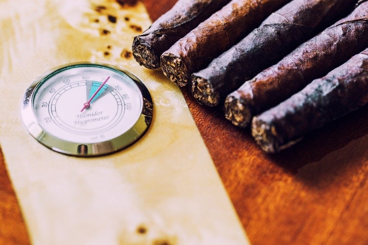 cigar advisor best glass top humidor guide - hygrometer with cigars in the background