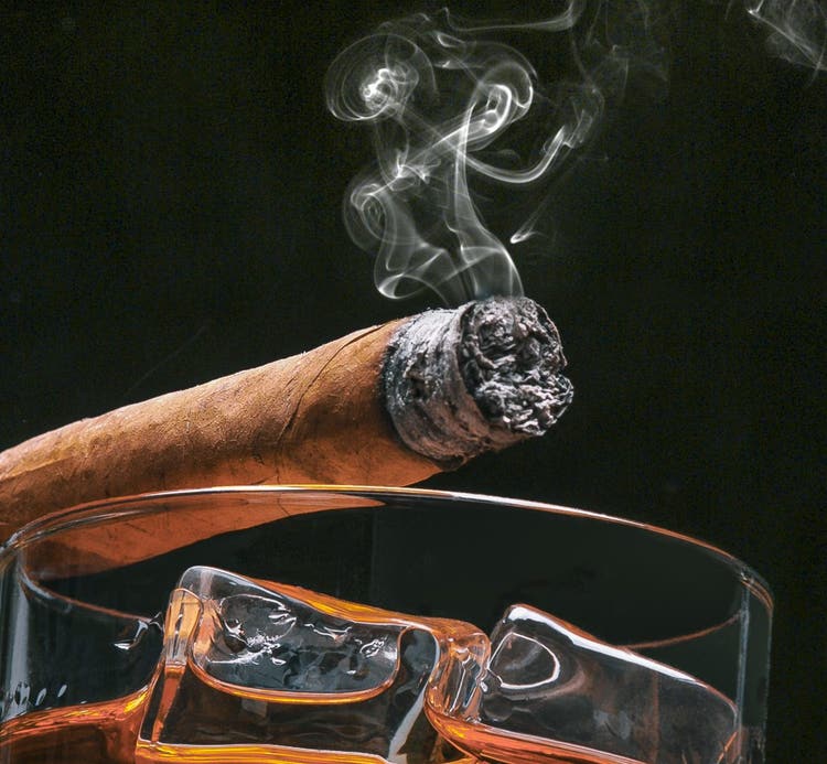 cigar aroma the smoke rising off the cigar and glass of whiskey