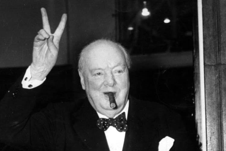 cigar advisor top 10 churchill cigars under $10 - sir winston churchill giving peace sign and smoking a cigar