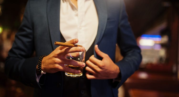 man with suit, cigar, and whisky