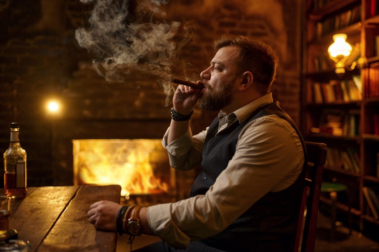 man smoking a cigar alone