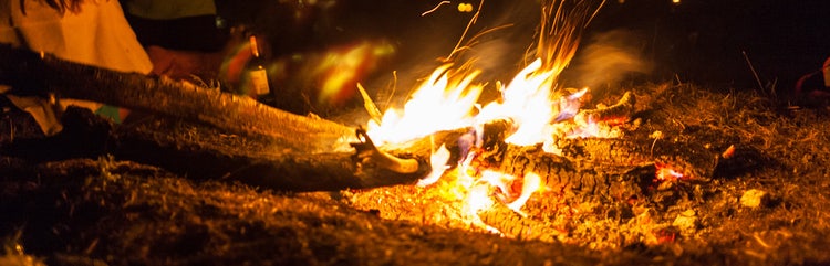 smoking cigars outside by the fire