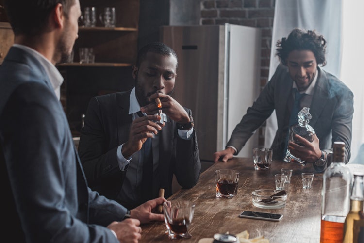 men smoking cigars socially