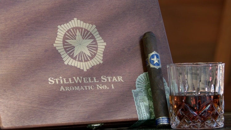 cigar advisor #nowsmoking cigar review stillwell star aromatic no. 1 by dunbarton tobacco & trust cigar leaning against box with whiskey glass