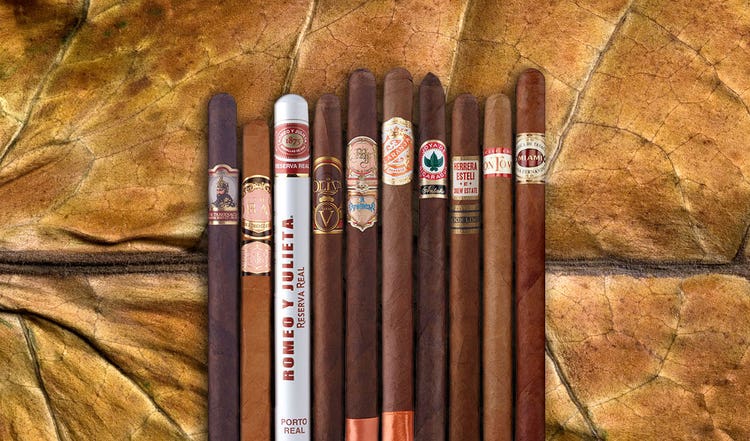 an assortment of lancero cigars on a tobacco leaf - 5 things to know about lancero cigars