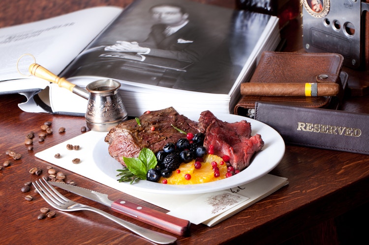 cigar advisor food for thought: using food to choose the best cigar fo you - set up shot of a plate of food with a cigar nearby