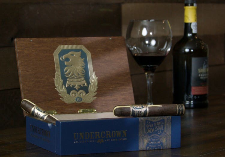 cigar advisor #nowsmoking cigar review - drew estate liga undercrown 10 setupl with cigar on box with wine in the background