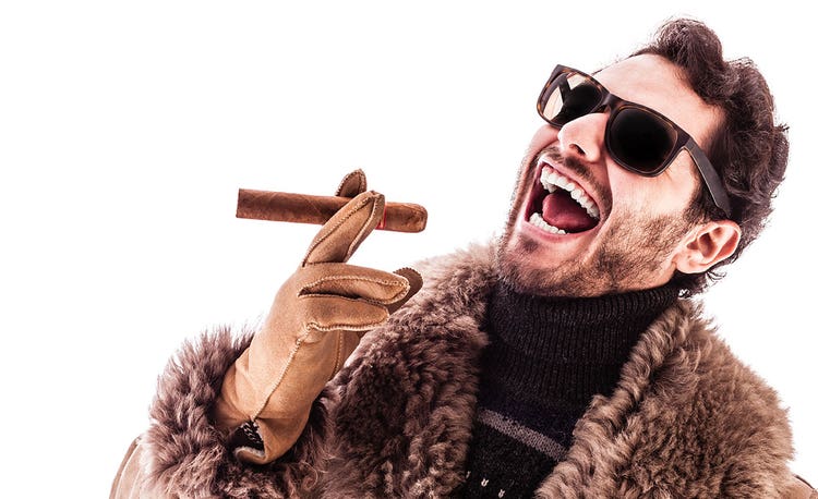 an image of a man smoking a cigar while wearing a winter coat.