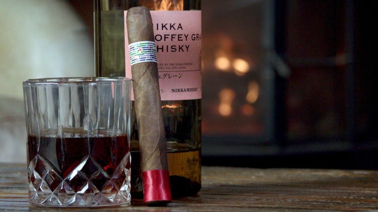 cigar advisor my weekend cigar review ozgener family pi synesthesia red - cigar next to whisky glass and learning against bottle