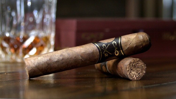 cao mx2 robusto #nowsmoking cigar review shot of two cigars with box and glass in the background