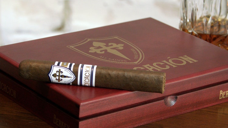 All Saints Dedicacion Berkey cigar review cigar resting on top of its box