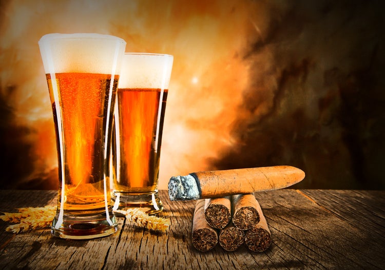 cigar advisor top three cigar and beer pairing mistakes - setup shot of beers and cigars