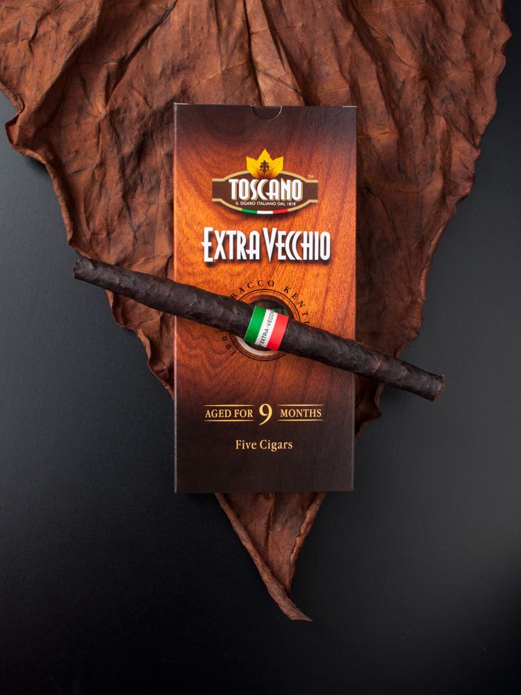 cigar advisor news-toscano extravecchio cigar release-5 pack and cigar on tobacco leaf