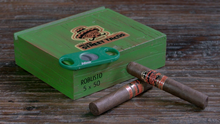 cigar advisor #nowsmoking cigar review rojas street tacos setup shot of cigars in front of box with a cutter
