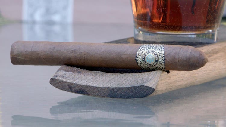 cigar advisor my weekend cigar review warped sky moon - setup shot of cigar on a whisky barrel stave and a rocks glass in the background