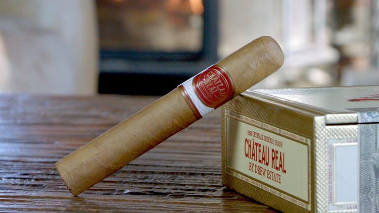 cigar advisor my weekend cigar review chateau real by drew estate - setup shot of cigar leaning on box