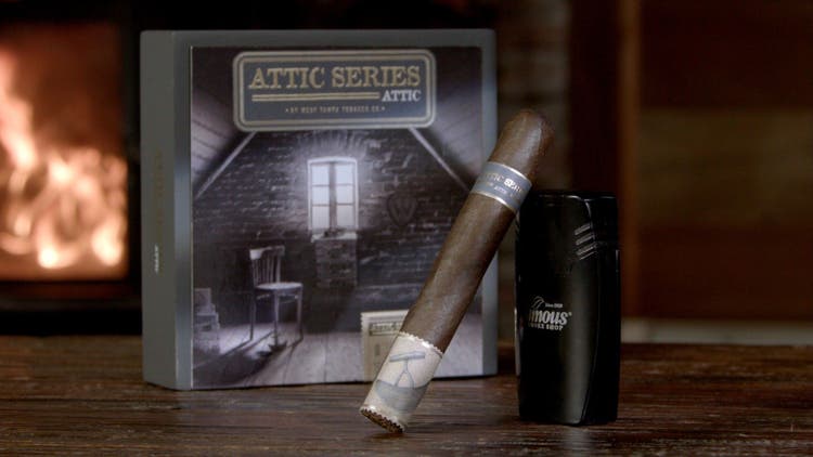 cigar advisor #nowsmoking cigar review west tampa attic series - setup shot of box, with a cigar leaning on a lighter in the foreground