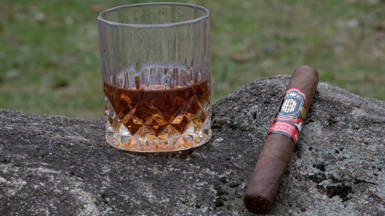 cigar advisor nowsmoking cigar review crowned heads serie e cigar and whiskey glass on stone