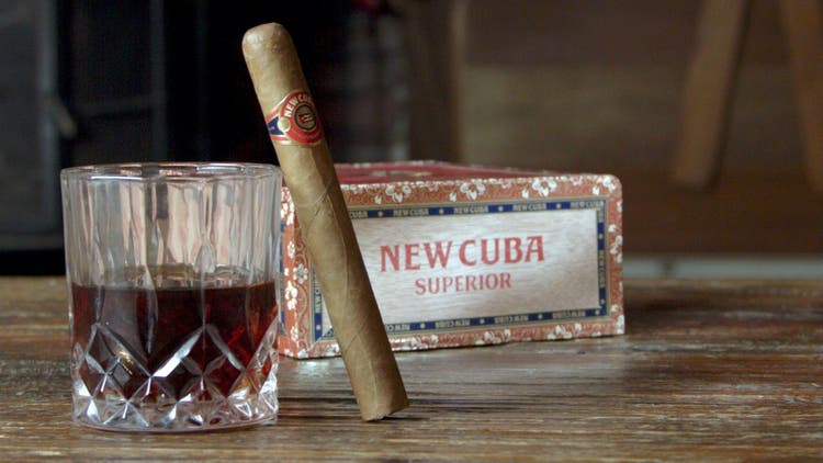cigar advisor my weekend cigar review new cuba superior connecticut - setup shot of cigar leaning on rocks glass with box in the background