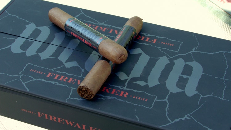 2 cigars on top of the CAO Arcana Firewalker cigar review box