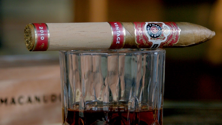 cigar advisor #nowsmoking cigar review - macanudo vintage 2010 setup shot of cigar on whiskey glass