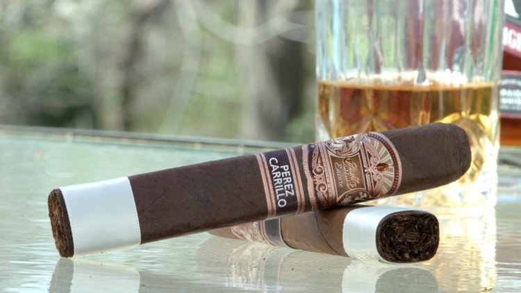cigar advisor #nowsmoking cigar review of e.p. carrillo encore toro - two cigars with whiskey glass in the background