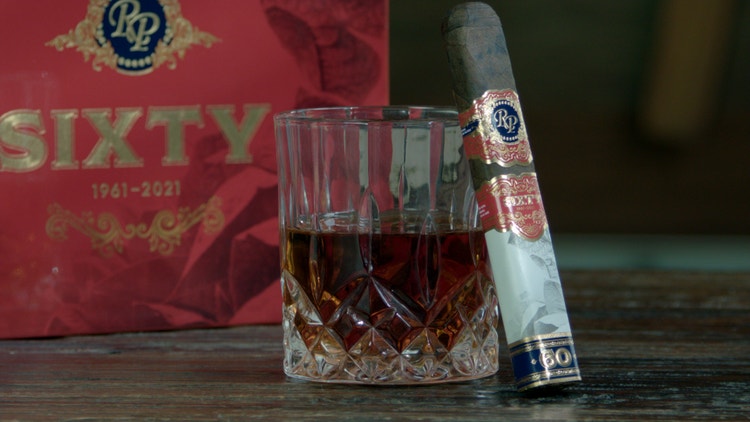 cigar advisor #nowsmoking cigar review (video) sixty by rocky patel - cigar leaning on whiskey glass with box in the background