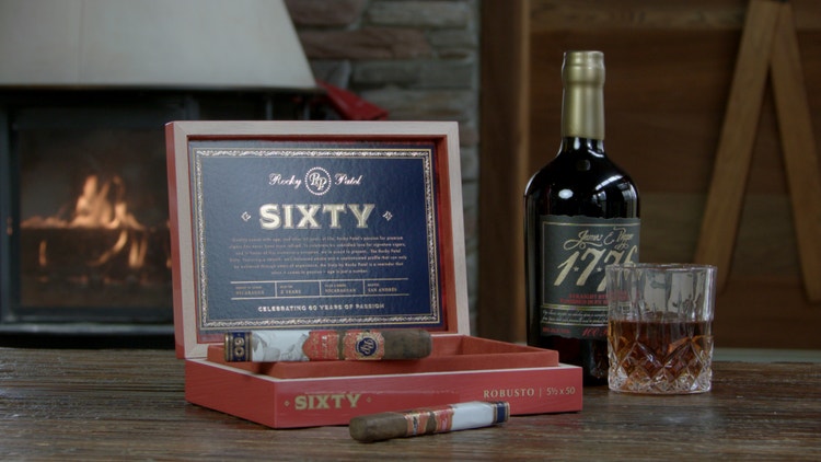 cigar advisor #nowsmoking cigar review (video) sixty by rocky patel - cigars and box with spirits, whiskey glass, and fireplace in the background