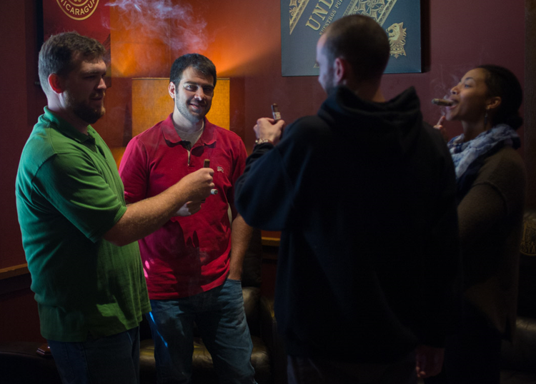 Group of smokers enjoying a cigar at Famous Smoke Shop