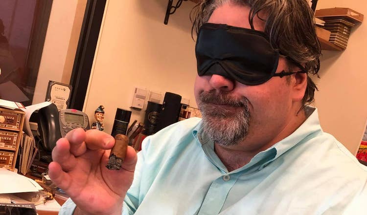 cigar advisor 2021 top 10 cigars of the year john pullo in blindfold smoking a cigar