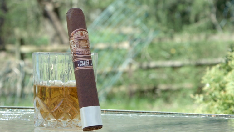 cigar advisor #nowsmoking cigar review of e.p. carrillo encore toro - cigar leaning against whiskey glass