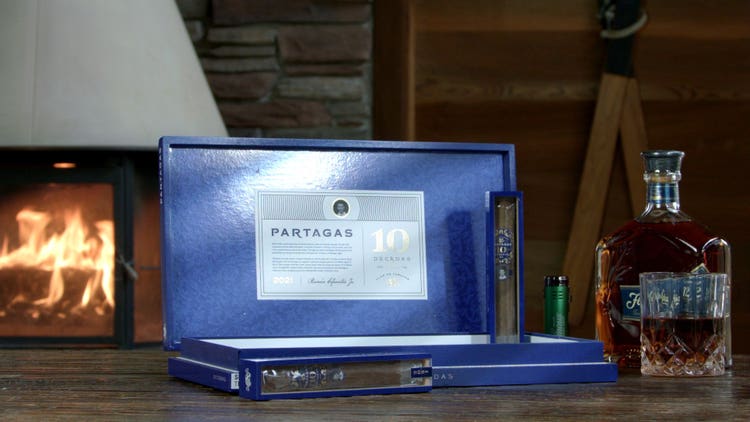 cigar advisor #nowsmoking cigar review of partagas limited reserve decadas 2021 - setup shot of cigar with coffin boxes displayed on top and in front