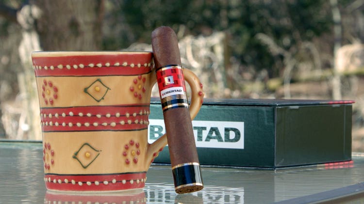 cigar advisor #nowsmoking cigar review villiger la libertad - shot of cigar leaning against coffee mug with box in the background